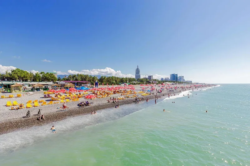 Batumi beach in high season, with the city behind it